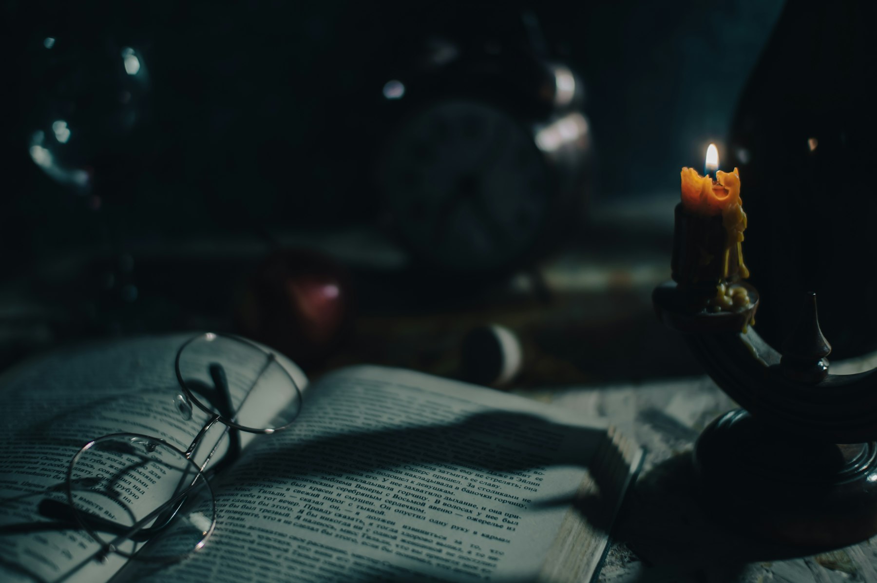 Lit candle resting on an open book, a moment of clarity