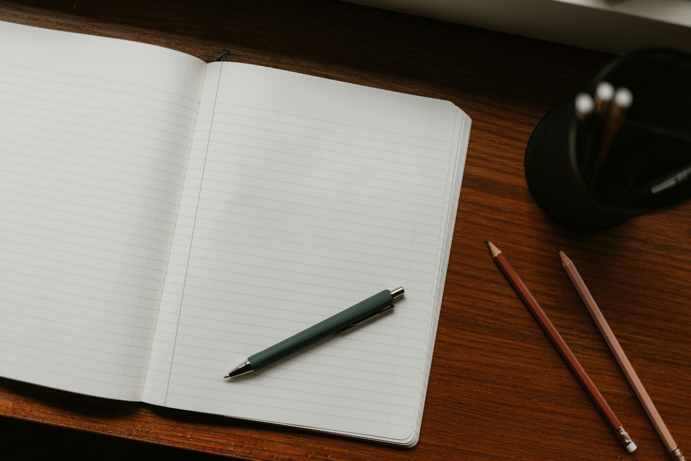 Open notebook with a pen on a desk for a limiting belief audit workbook