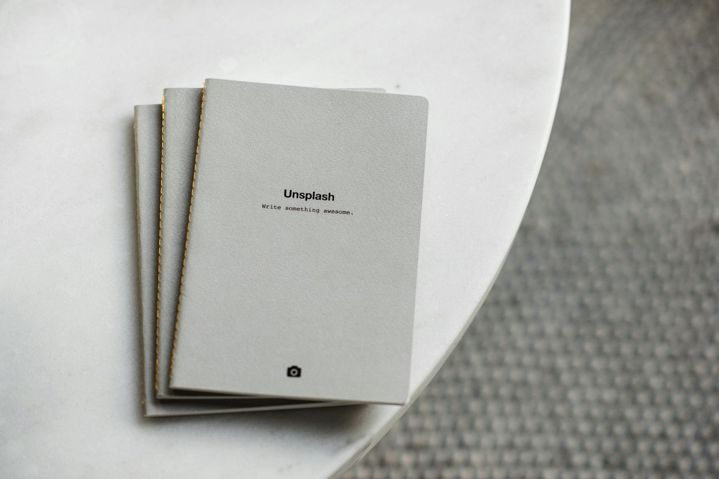 Three white softbound books stacked together as a complete bundle