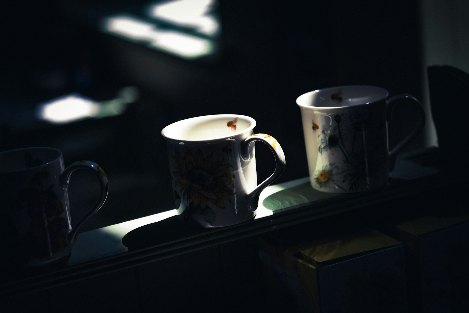 Three mugs in dappled sunlight, a calm gathering space for group coaching